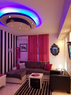 a living room with a couch and a blue light at Black & White in Belgrade