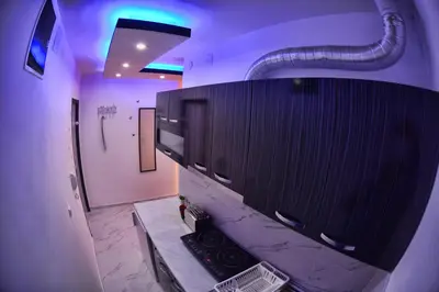 a bathroom with a shower with a television and a pipe at Black & White in Belgrade