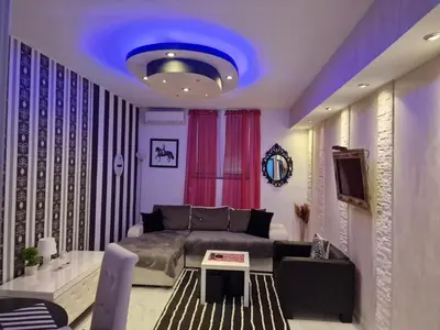 a living room with a couch and a blue ceiling at Black & White in Belgrade