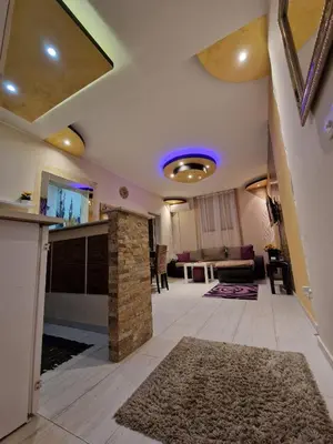 a living room with a stone fireplace and a living room at Gold in Belgrade