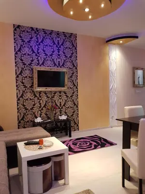 a living room with a purple accent wall at Gold in Belgrade