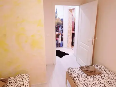 a room with two beds and a hallway with a door at Gold in Belgrade