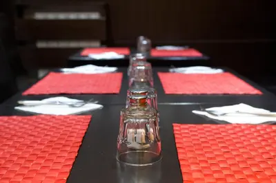 a table with red napkins and two glass bottles at Vila Senjak in Belgrade