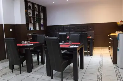 a dining room with black tables and black chairs at Vila Senjak in Belgrade