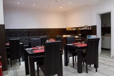 a dining room with black tables and black chairs at Vila Senjak in Belgrade