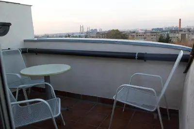 a table and chairs on a balcony with a view at Vila Senjak in Belgrade