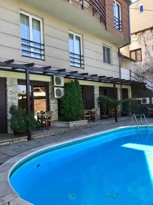 a swimming pool in front of a building at Vila Senjak in Belgrade
