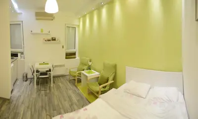 a bedroom with a bed and a desk and a table at Kate Apartment Belgrade in Belgrade