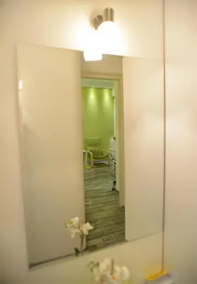 a mirror on a wall in a bathroom at Kate Apartment Belgrade in Belgrade