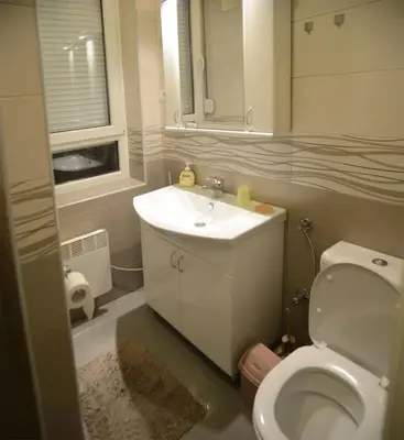 a bathroom with a white sink and a toilet at Kate Apartment Belgrade in Belgrade