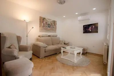 a living room with a couch and a table at Apartments near St. Sava Temple in Belgrade