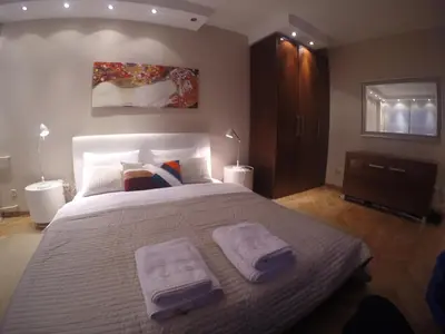 a bedroom with a large bed with two towels on it at Apartments near St. Sava Temple in Belgrade