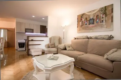 a living room with a couch and a table at Apartments near St. Sava Temple in Belgrade