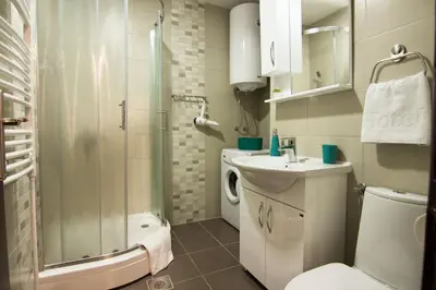 a bathroom with a toilet sink and a shower at Apartments near St. Sava Temple in Belgrade