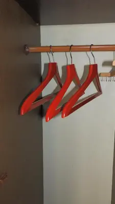 a group of four red hangers in a room at Jelena Apartment in Belgrade