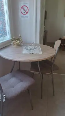 a wooden table with two chairs and a no smoking sign at Jelena Apartment in Belgrade
