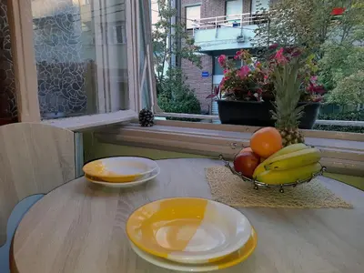 a table with a bowl of fruit on a table at Jelena Apartment in Belgrade
