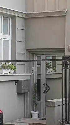 a house with a porch with potted plants on it at Jelena Apartment in Belgrade