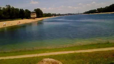 a large body of water with people on a beach at Jelena Apartment in Belgrade