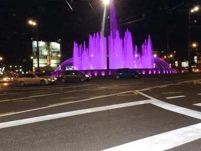 a fountain in the middle of a city at night at Jelena Apartment in Belgrade