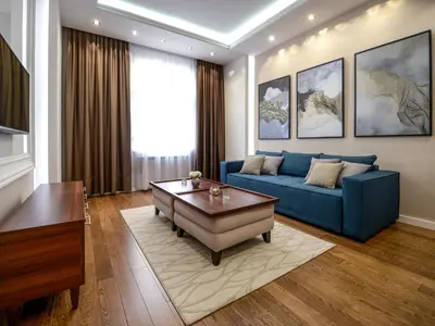 a living room with a blue couch and a table at Main Square Residence in Belgrade
