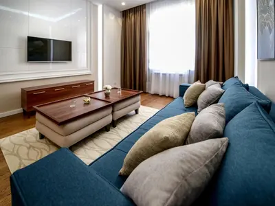 a living room with a blue couch and a table at Main Square Residence in Belgrade