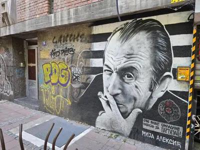a wall with a large painting of a man on it at Dafni Apartment in Belgrade