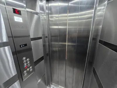 a large metal elevator in a stainless steel room at Dafni Apartment in Belgrade