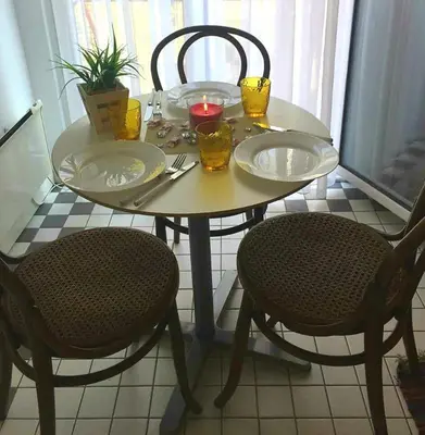a table with two plates and two chairs and a candle at Apartment Jastuk in Belgrade