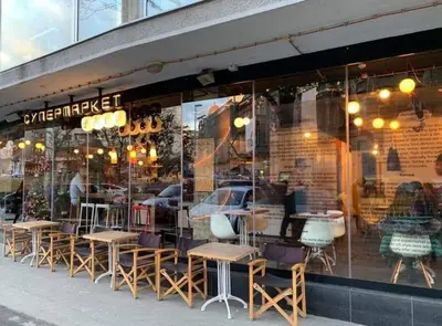 a store with tables and chairs in a window at Apartment Jastuk in Belgrade