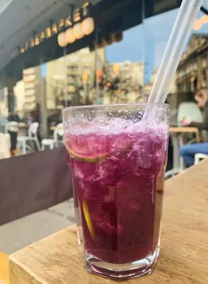 a drink with a straw sitting on a table at Apartment Jastuk in Belgrade