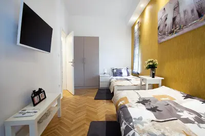 a small room with a bed and a tv at Apartment Passage in Belgrade