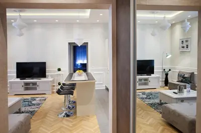 a living room with a couch and a table with a chair at Apartment Passage in Belgrade