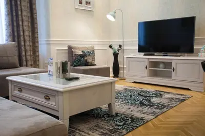 a living room with a tv and a coffee table at Apartment Passage in Belgrade