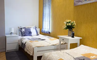 a bedroom with a bed and a table with flowers on it at Apartment Passage in Belgrade