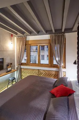 a bedroom with a large bed with a red pillow at Subway in Belgrade