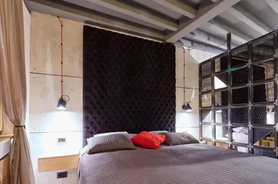 a bedroom with a bed with two red pillows at Subway in Belgrade