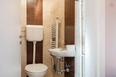 a bathroom with a toilet and a sink at Roof Penthouse 15th Floor in Belgrade