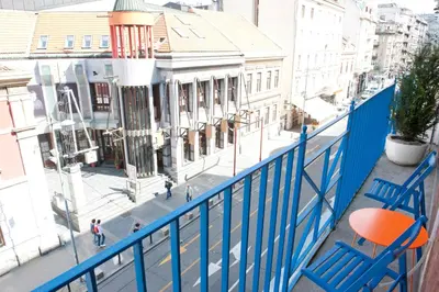 a blue chair sitting on top of a balcony at Atelje apartment in Belgrade