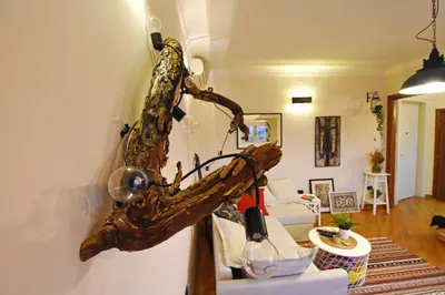 a living room with a tree branch on the wall at Charming Flat with Soul in Belgrade