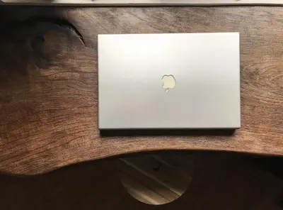 an apple laptop sitting on top of a wooden table at Charming Flat with Soul in Belgrade