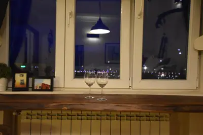 two wine glasses sitting on a window sill at Charming Flat with Soul in Belgrade