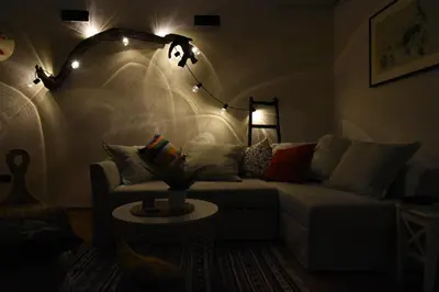 a living room with a couch and a lamp at Charming Flat with Soul in Belgrade