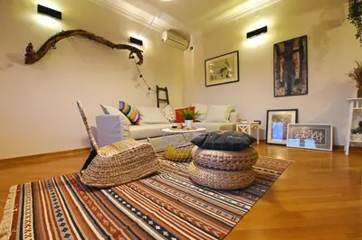 a living room with a couch and a rug at Charming Flat with Soul in Belgrade