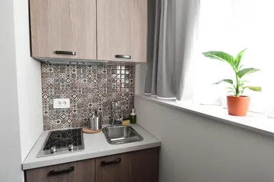 a kitchen with a stove and a sink and a window at Apartments Srbija - FREE PARKING in Belgrade