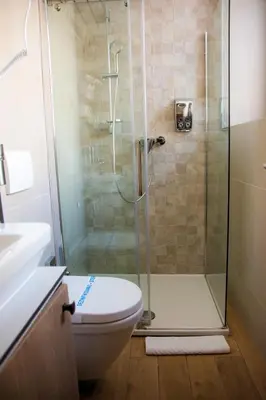 a bathroom with a shower and a toilet at Apartments Srbija - FREE PARKING in Belgrade