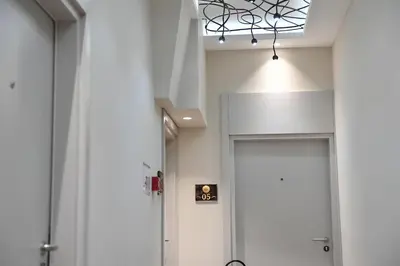 a hallway with a white door and a ceiling at Apartments Srbija - FREE PARKING in Belgrade