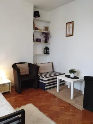 a living room with a couch and a table at Apartman Centar Beograd in Belgrade