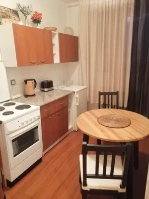 a kitchen with a white stove and a table at Apartman Centar Beograd in Belgrade