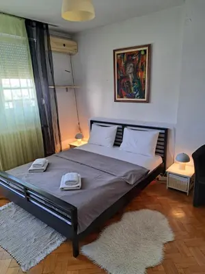 a bedroom with a bed with two towels on it at Apartman Centar Beograd in Belgrade